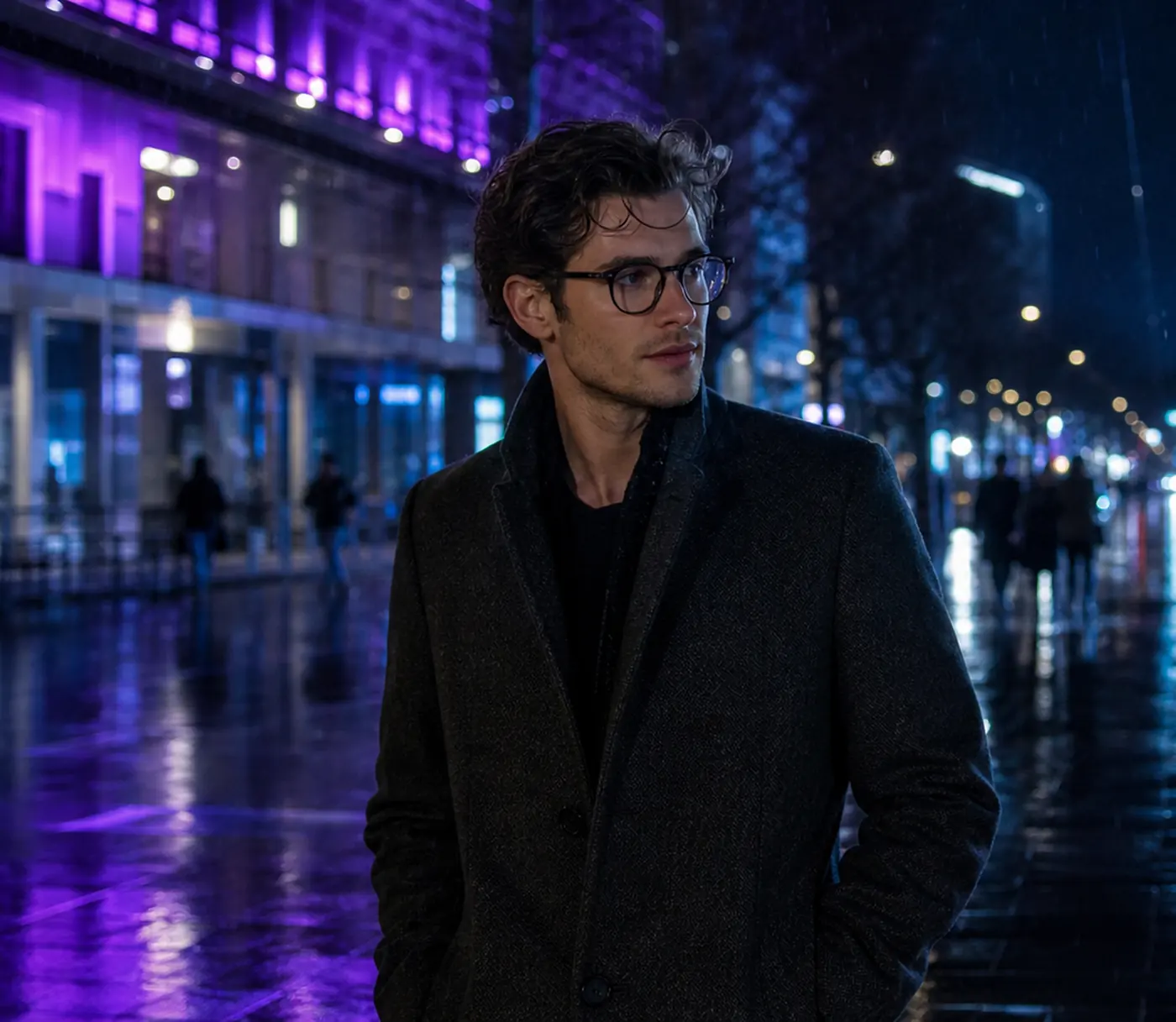 Man in round eyeglasses on a rainy city street at night