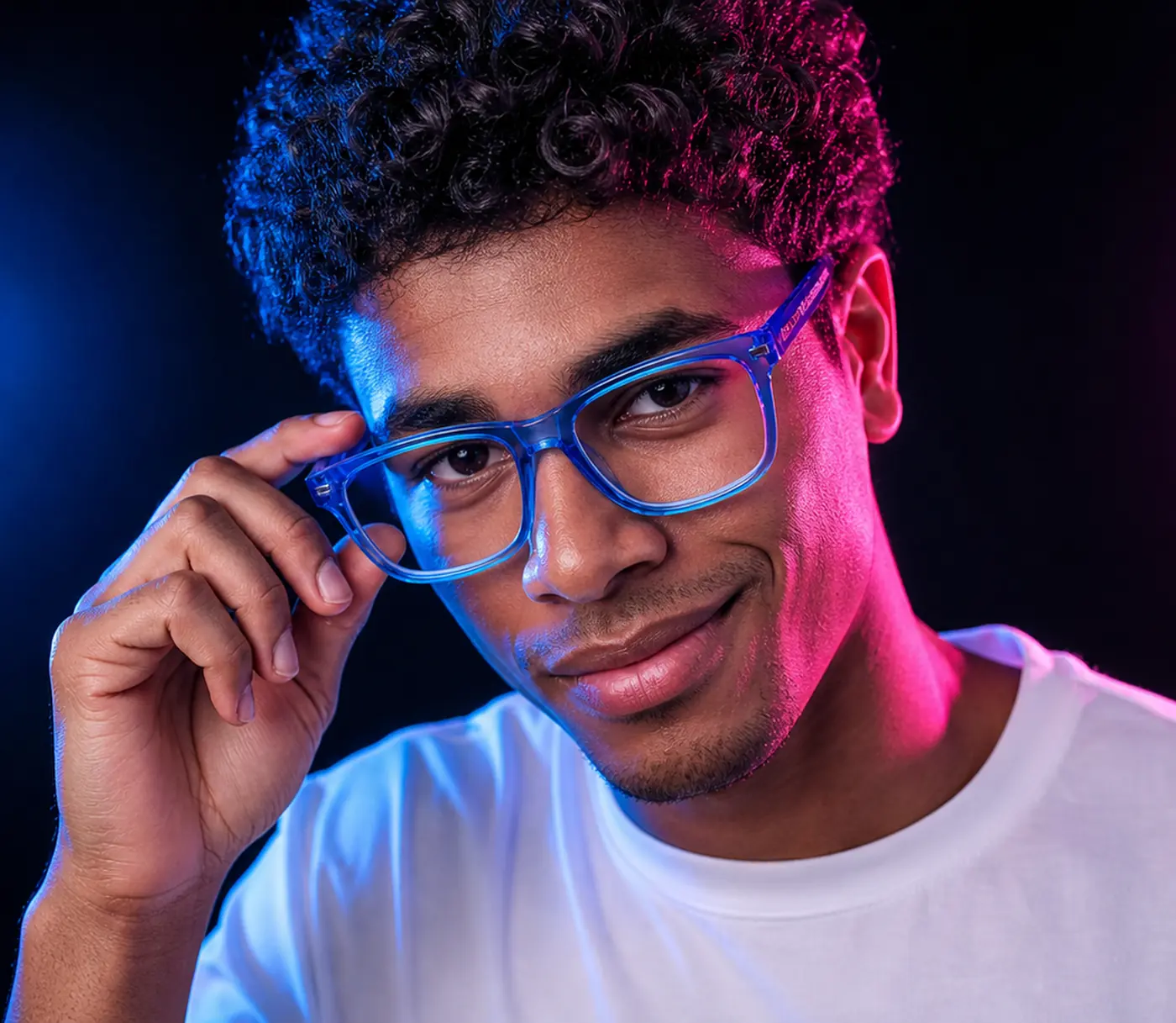 Young man adjusting blue translucent eyeglasses